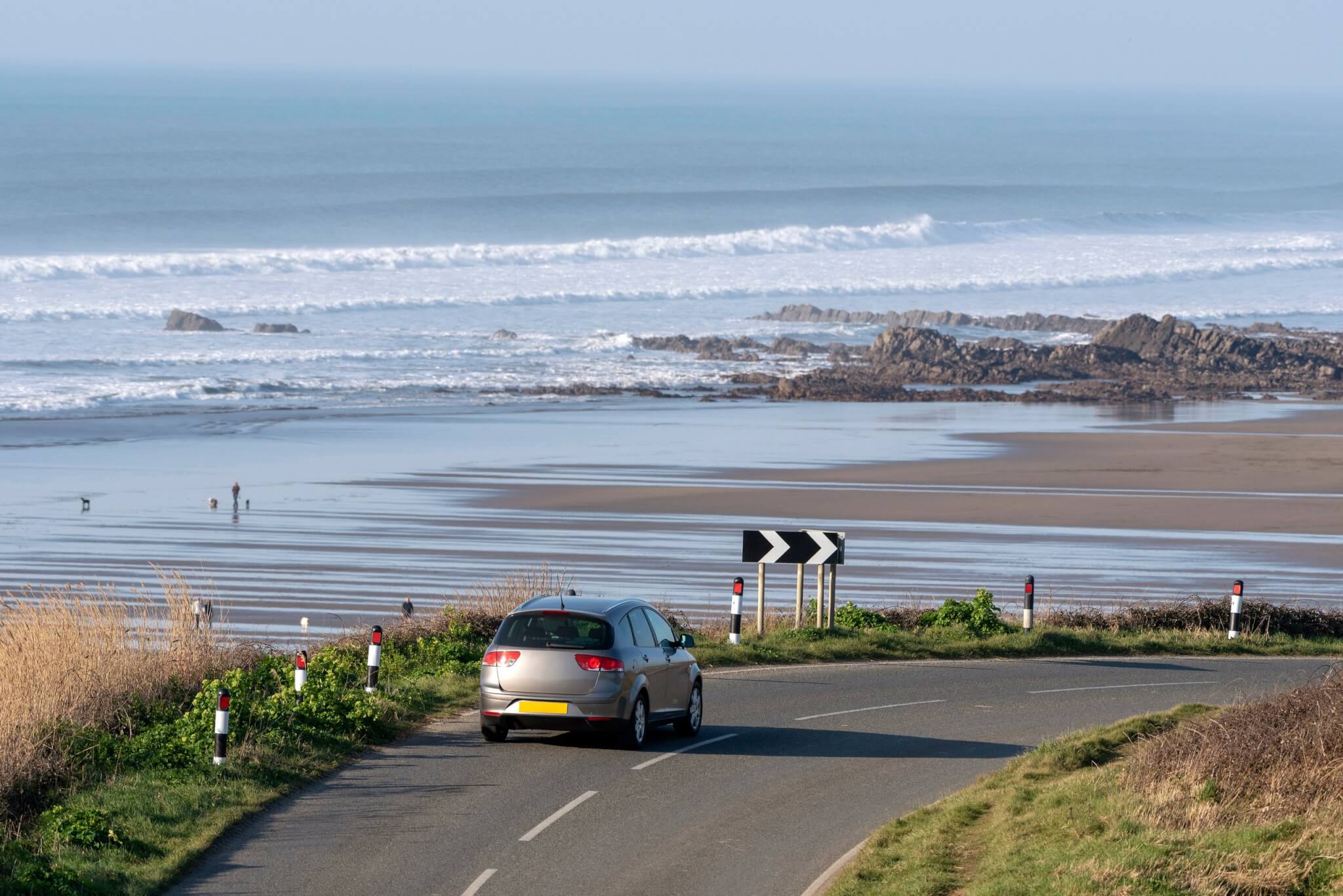 Car on a coastal road above Widemouth Bay in north Cornwall