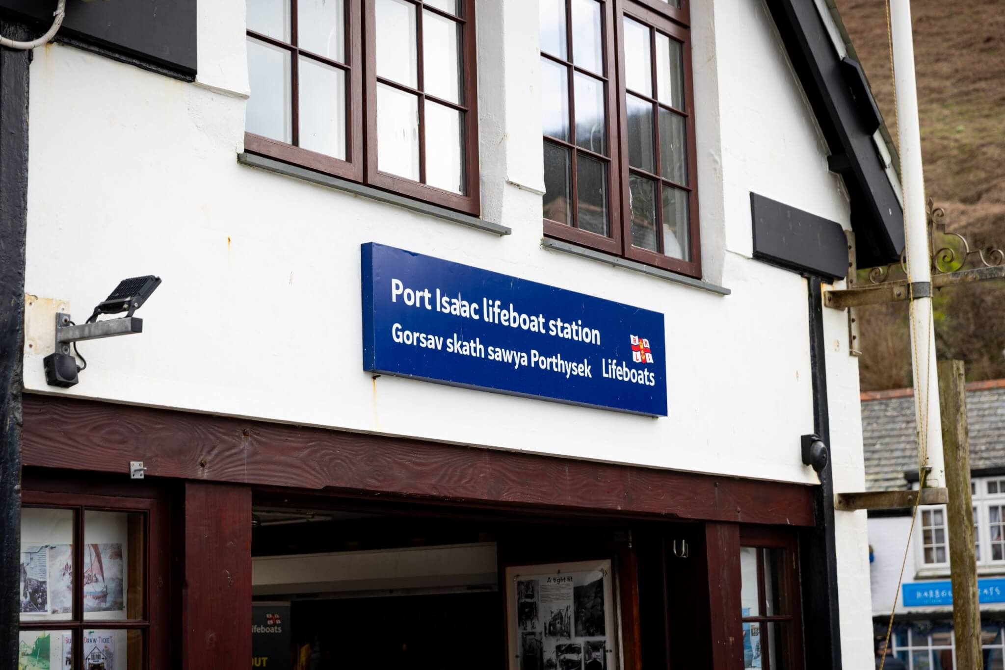 Port Isaac lifeboat station sign in English and Cornish