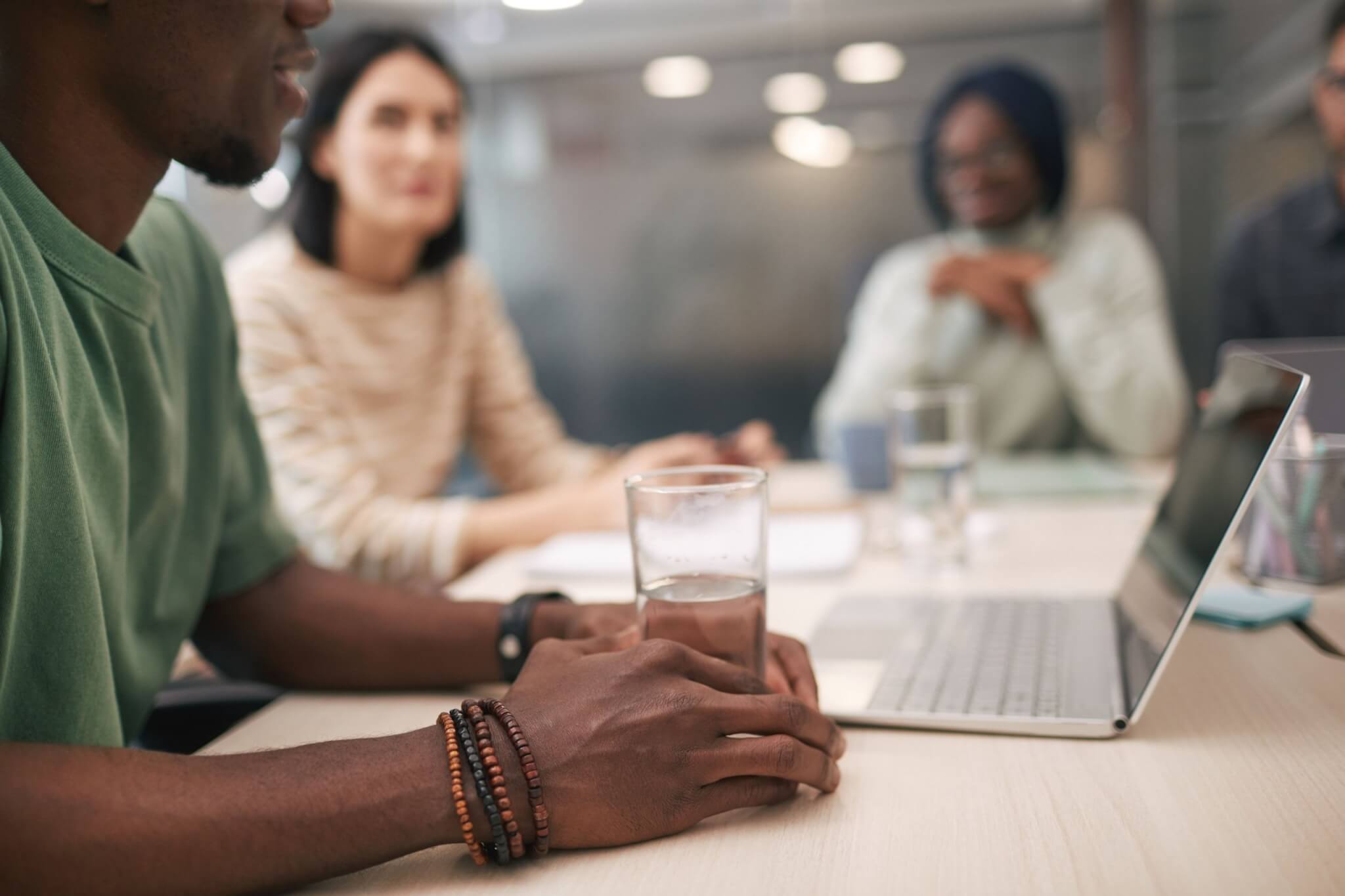 Colleagues talking around a meeting table