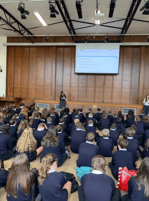 Students seated on the hall floor at Launceston College during an assembly