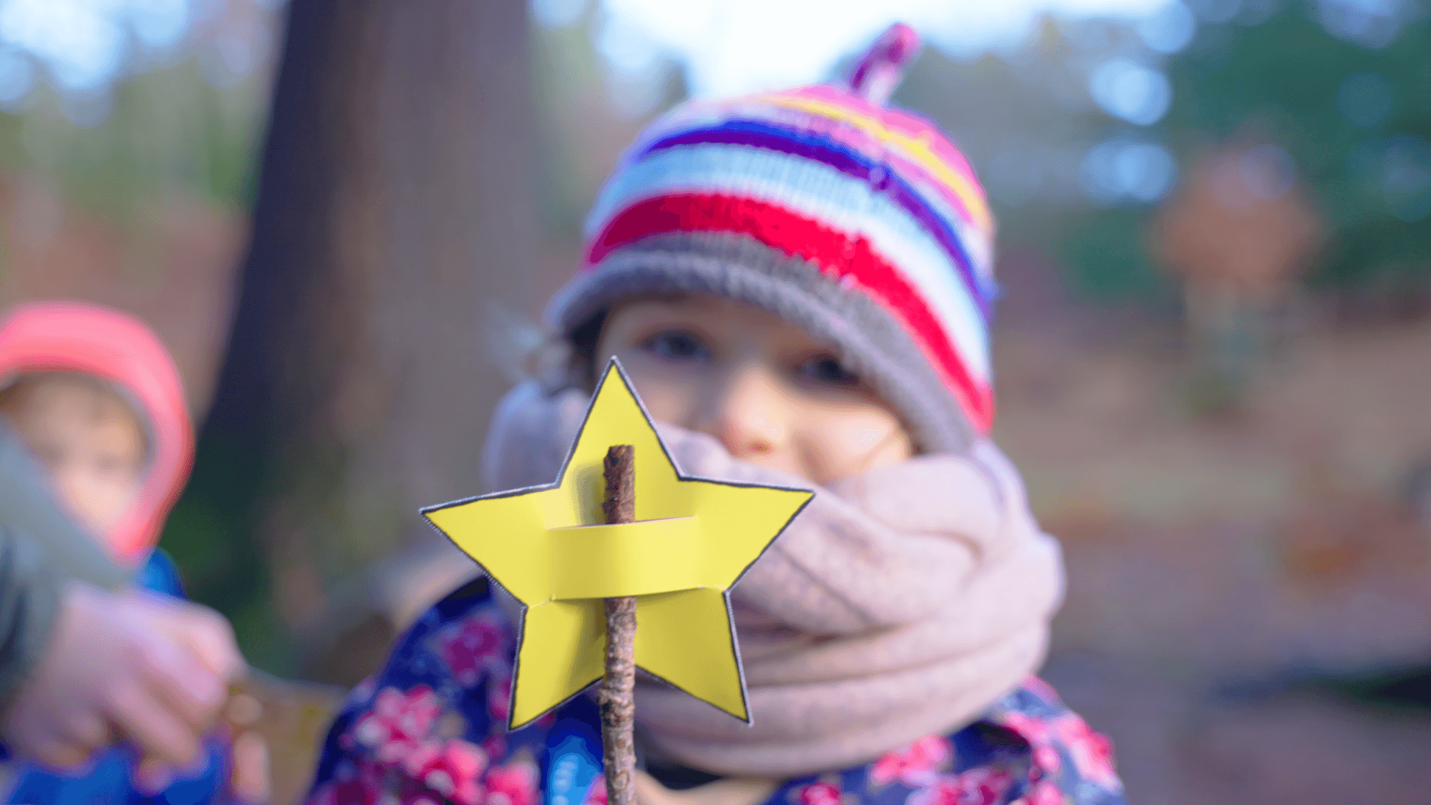 A child holding a paper star on a stick