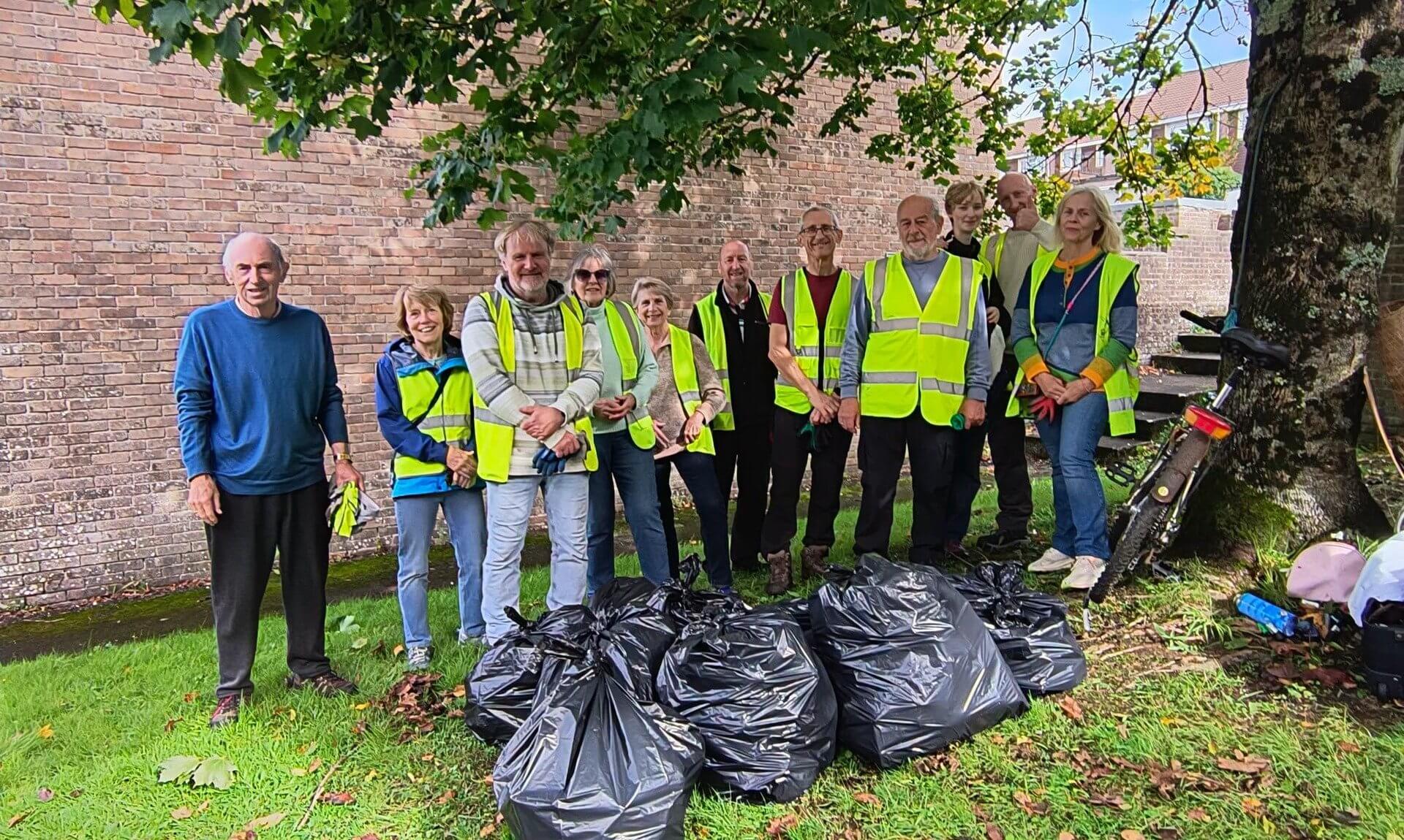 Bodmin Tidy it Team volunteers in hi-vis vests with bags of collected litter
