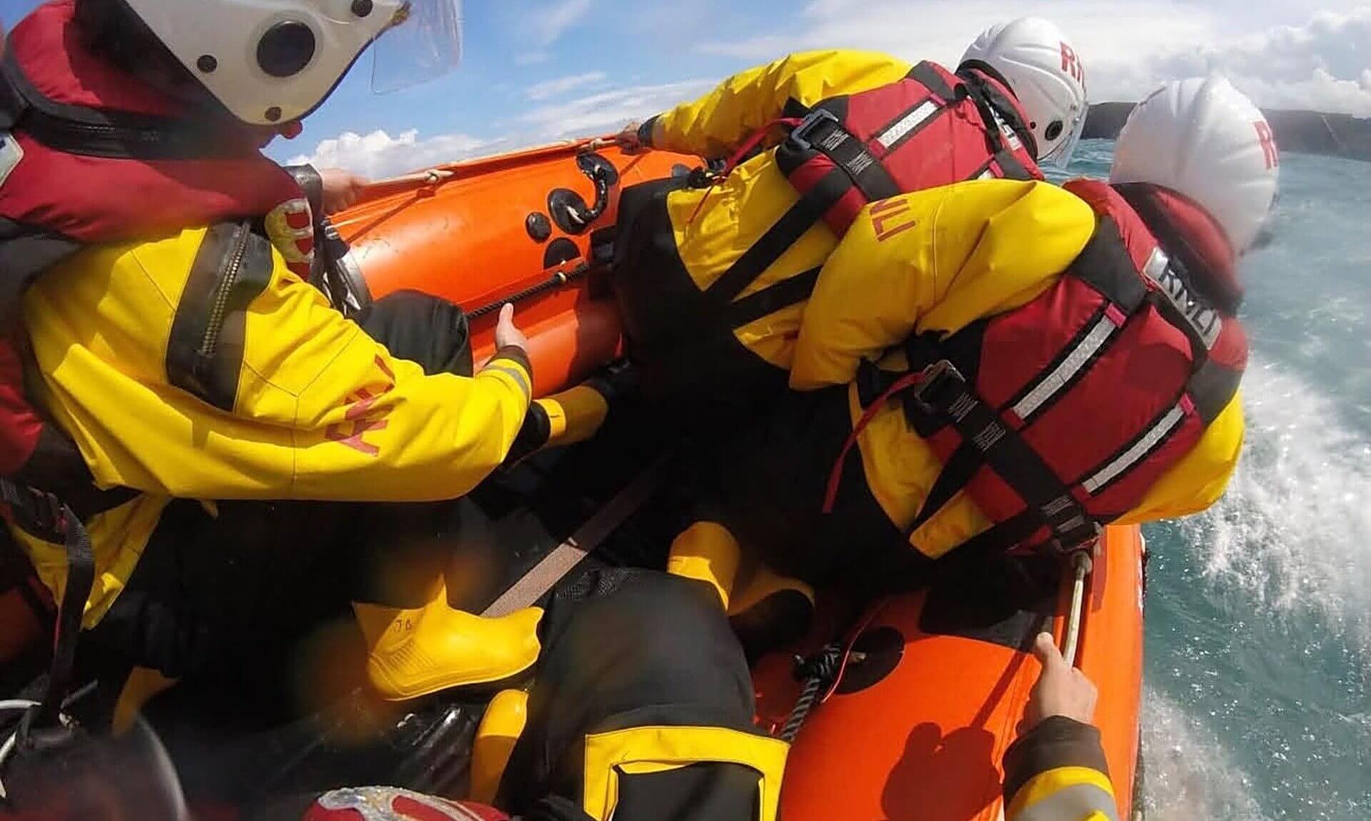 RNLI volunteer crew aboard an inshore lifeboat at sea