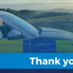 Police dog leaning out of a Devon and Cornwall Police car window with a thank you banner