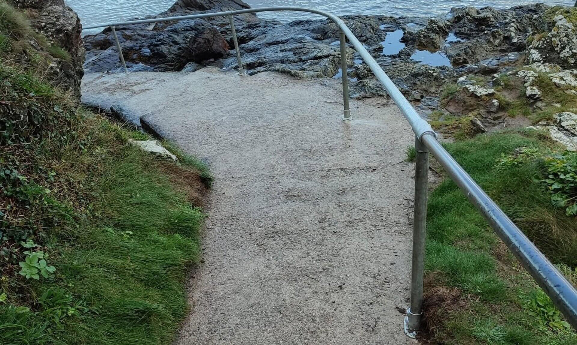 Galvanised handrail beside the path down to the water at Chidley Pump, Padstow