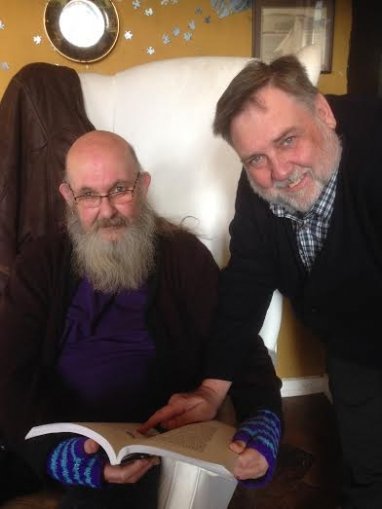 Two men looking at a book together, from the Cornish with Clive podcast