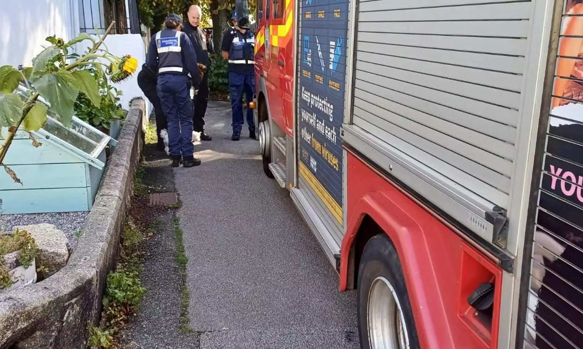 Fire engine parked beside officers on a Falmouth street during the Student Hello Visits