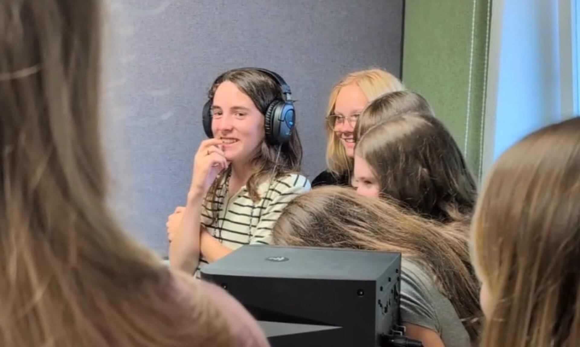 Falmouth youth councillors wearing headphones in the Source FM studio