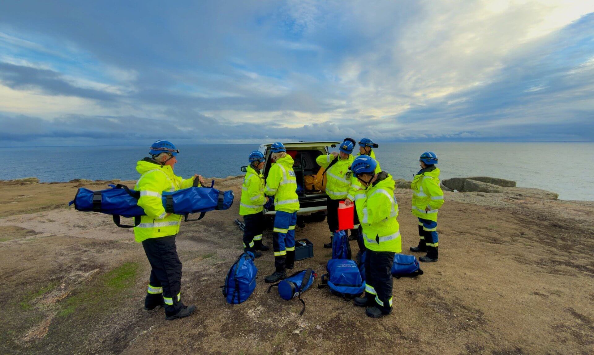 Land's End Coastguard Search and Rescue Team unloading kit from their vehicle on a clifftop