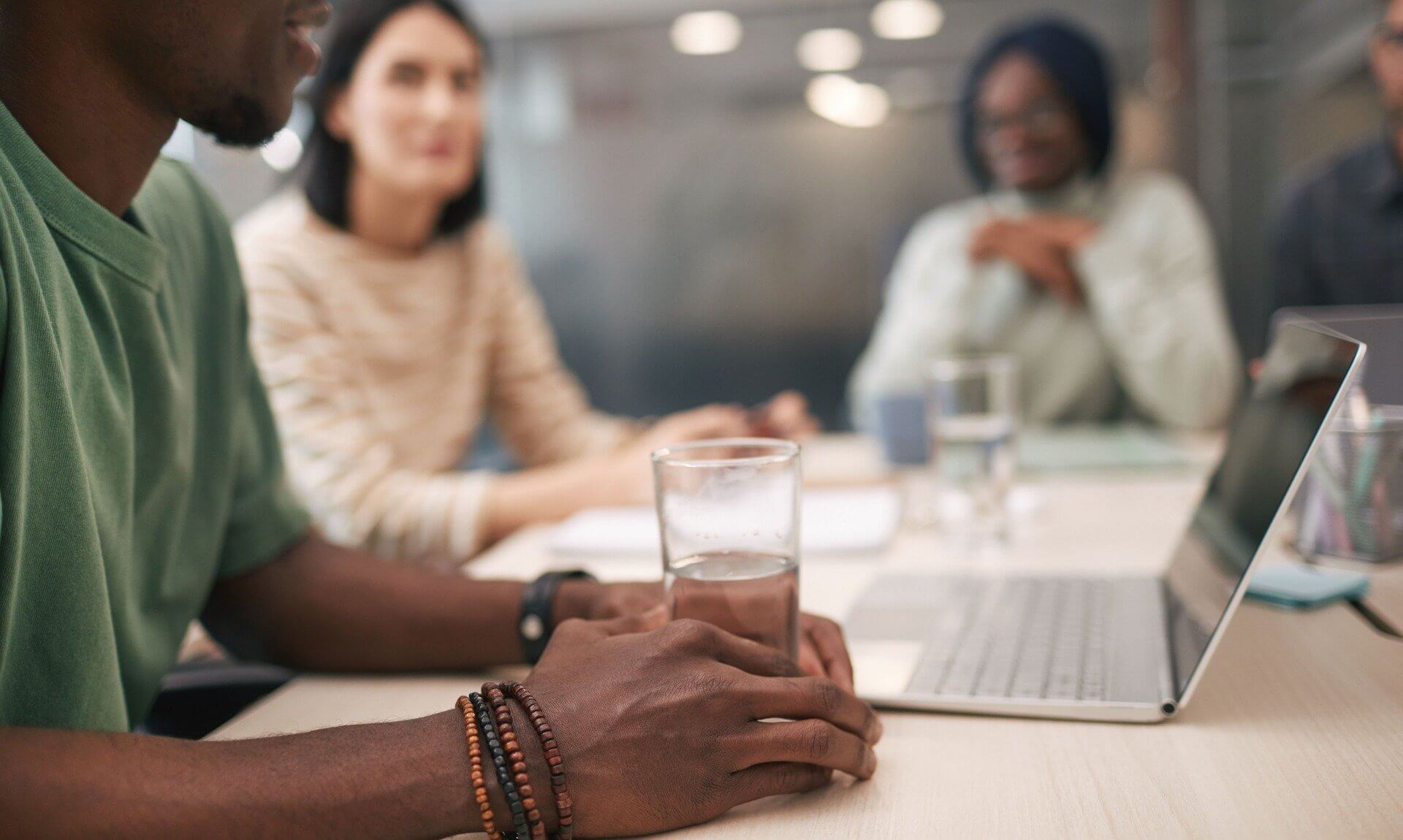 Colleagues talking around a meeting table