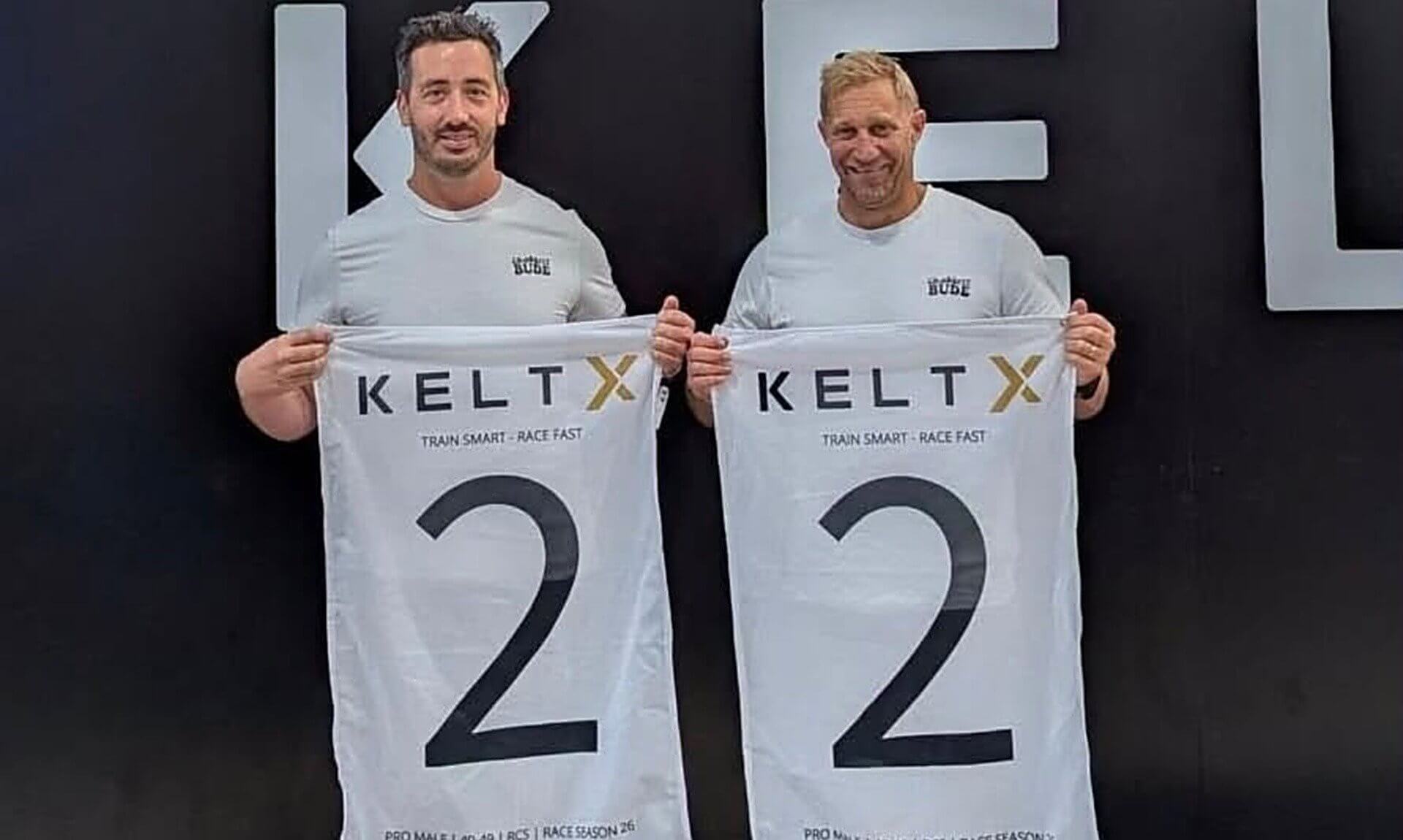 Bude lifeboat crew members Liam and Paul Corthine holding KeltX second place flags