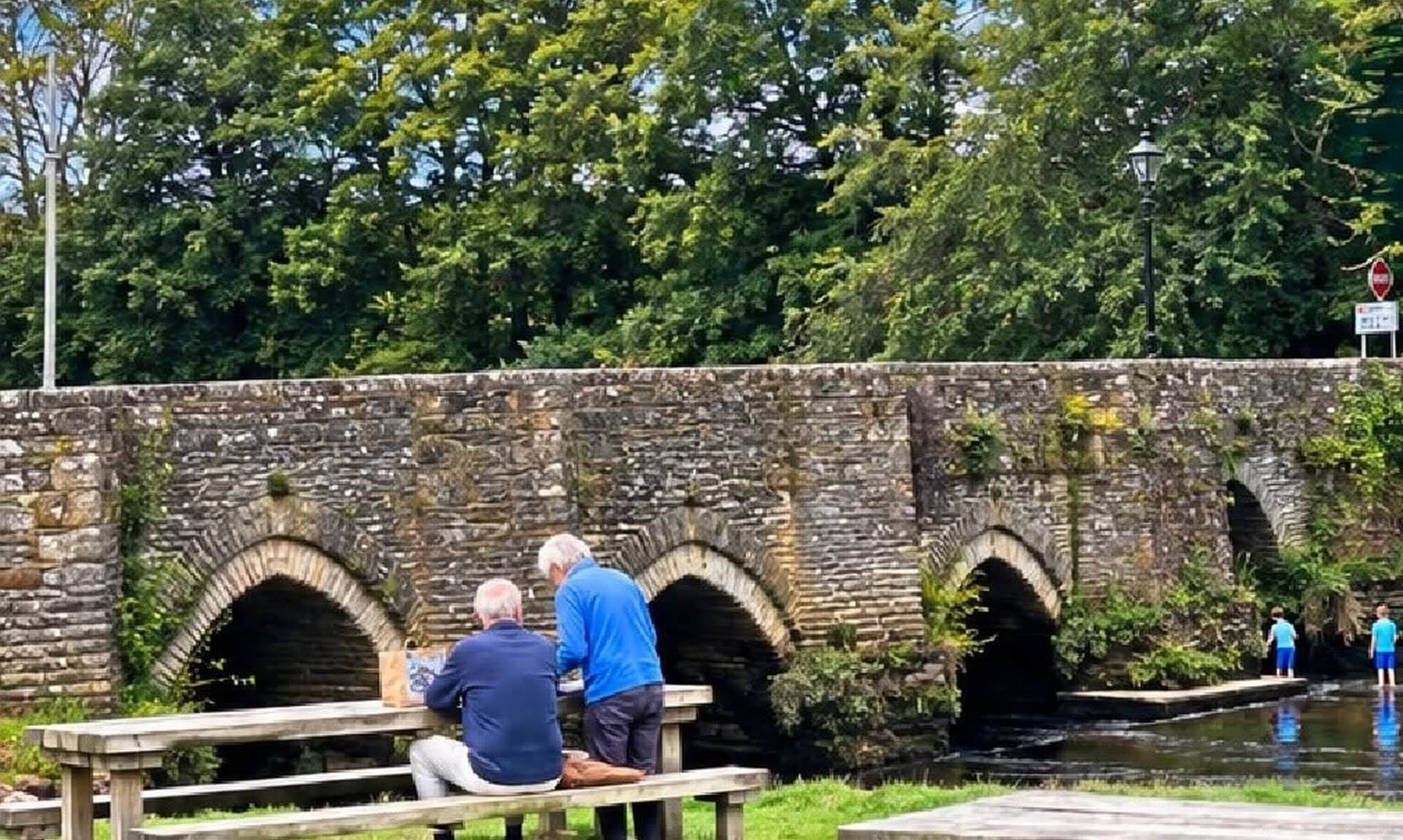 Picnic benches beside the stone bridge in Lostwithiel
