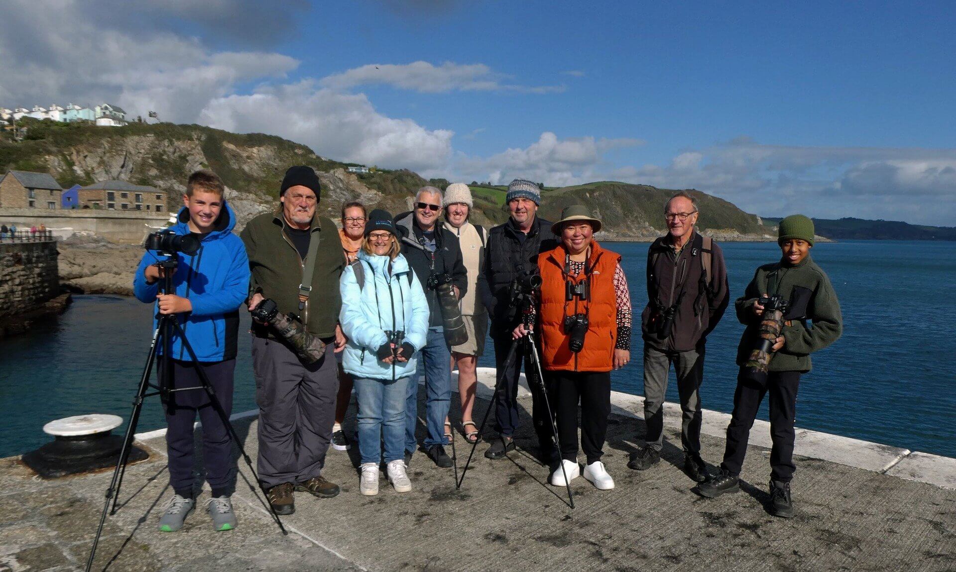 Birdwatching group with cameras and tripods on Mevagissey Harbour