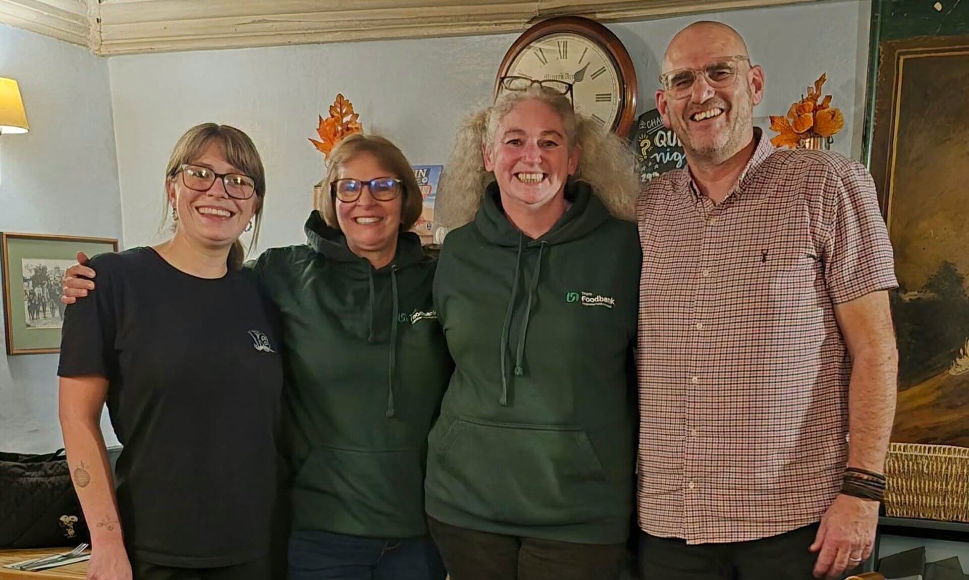 Truro Foodbank volunteers with staff at The Miners Arms, Mithian