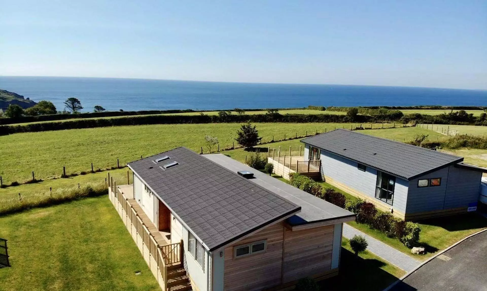Holiday lodges at Seaview Holiday Park near Gorran Haven with the sea beyond