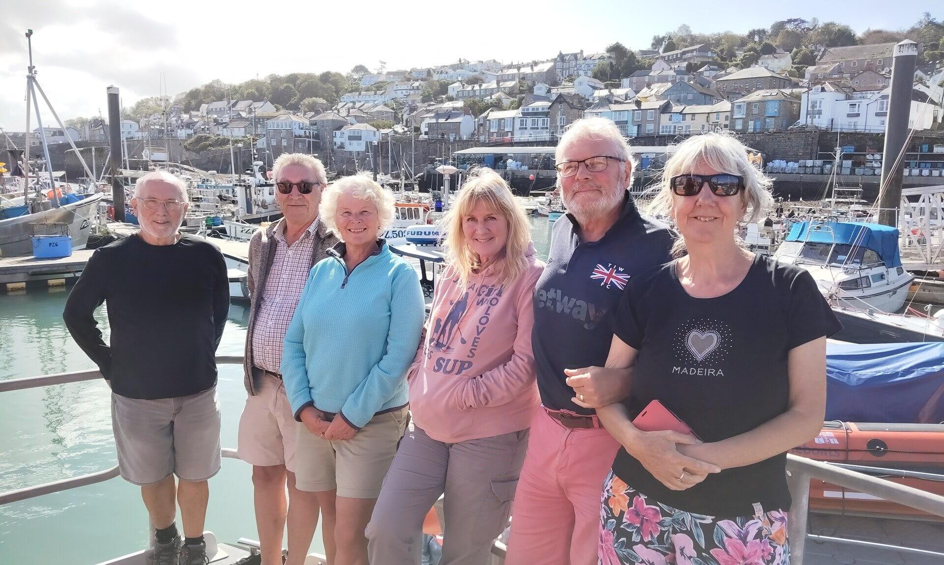 Guests on the VIP visit at Penlee Lifeboat Station with Newlyn harbour behind