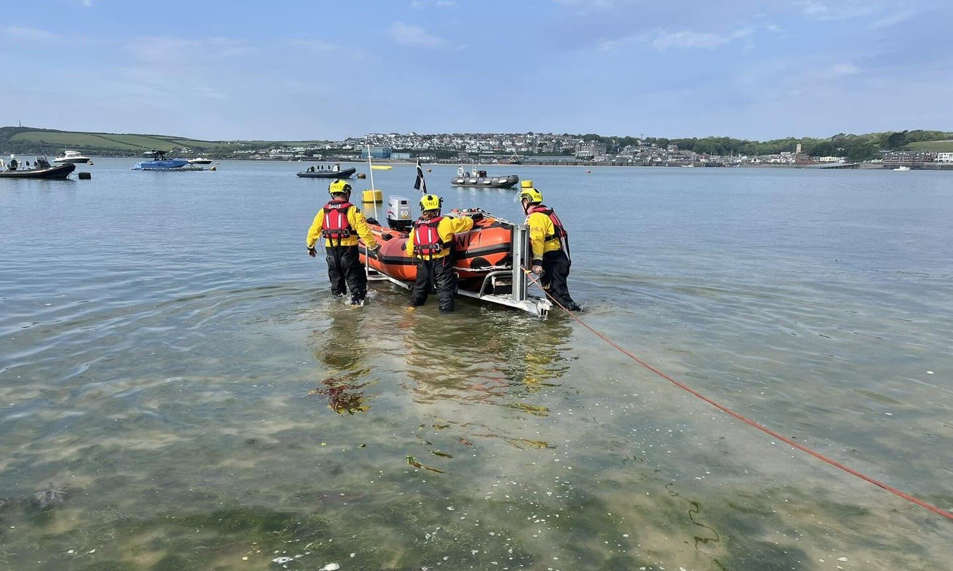 Rock RNLI volunteer crew launching the D class lifeboat into the Camel estuary