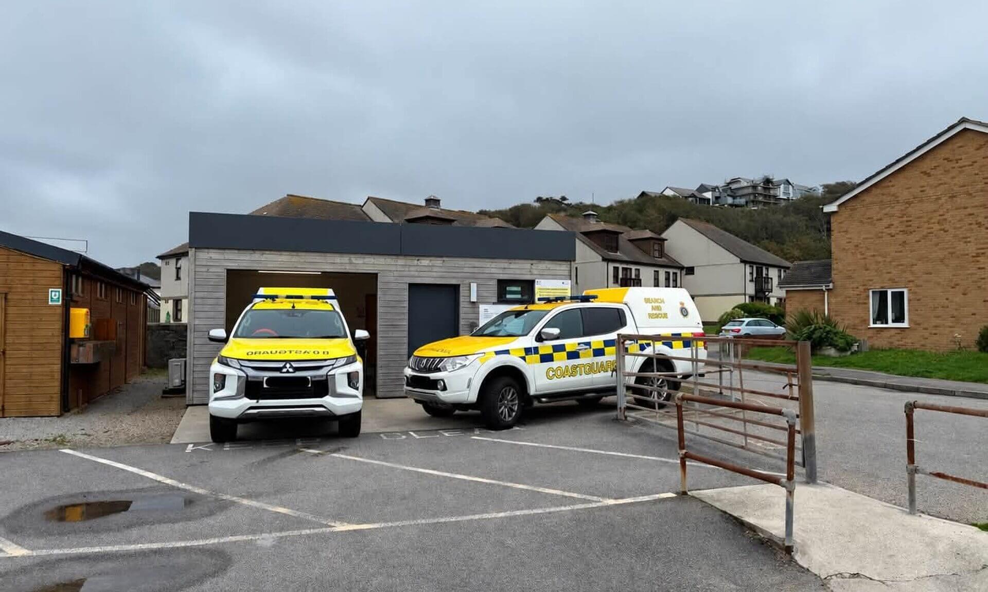 Two Coastguard search and rescue vehicles parked outside a building in Portreath