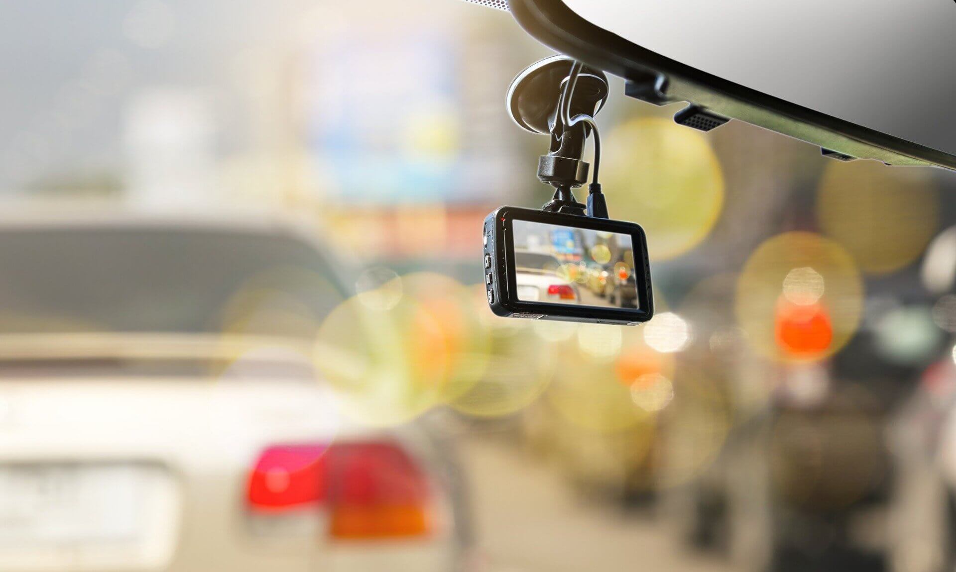 Dash-cam mounted on a car windscreen in traffic