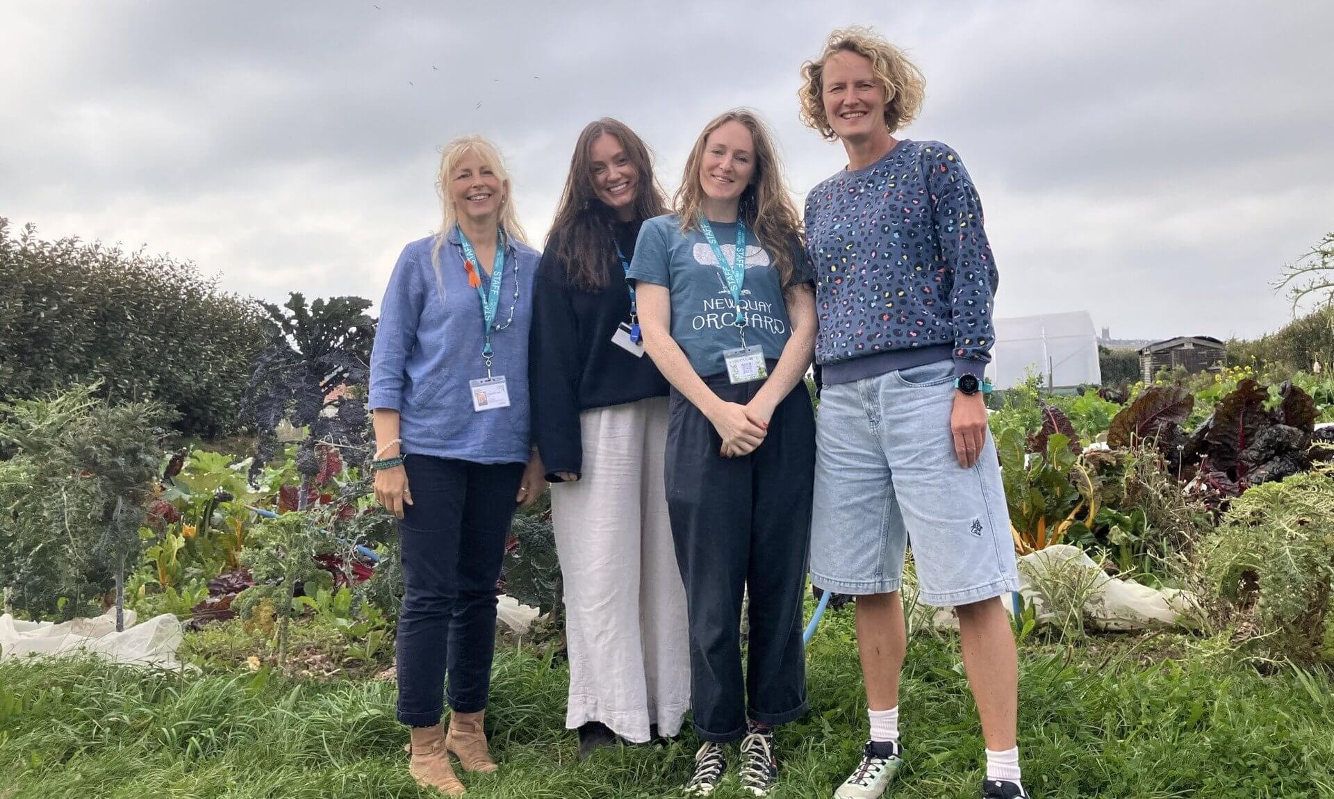 Four members of the Restormel CAMHS team standing in a vegetable garden