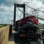 Drain cleansing tankers and a worker in hi-vis on the Tamar Bridge
