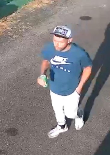 Man in a cap, blue Nike t-shirt and light trousers whom police want to identify after an assault in Torpoint