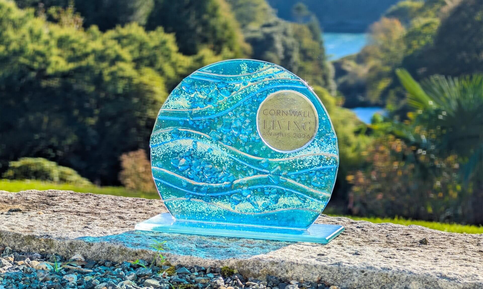 Cornwall Living Awards 2026 glass trophy with Trebah Garden's valley behind