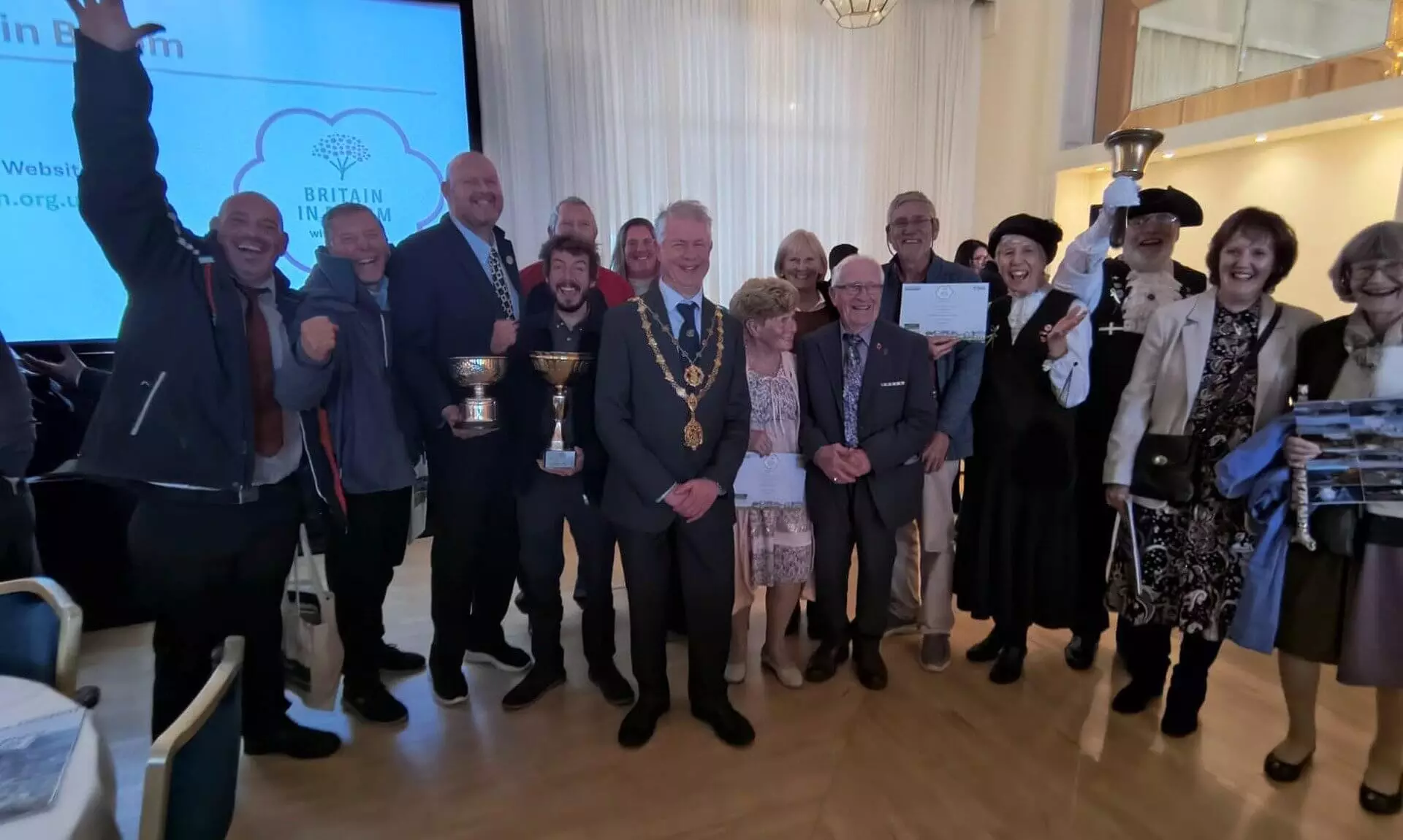 Truro's in Bloom team celebrating with trophies and certificates at the awards