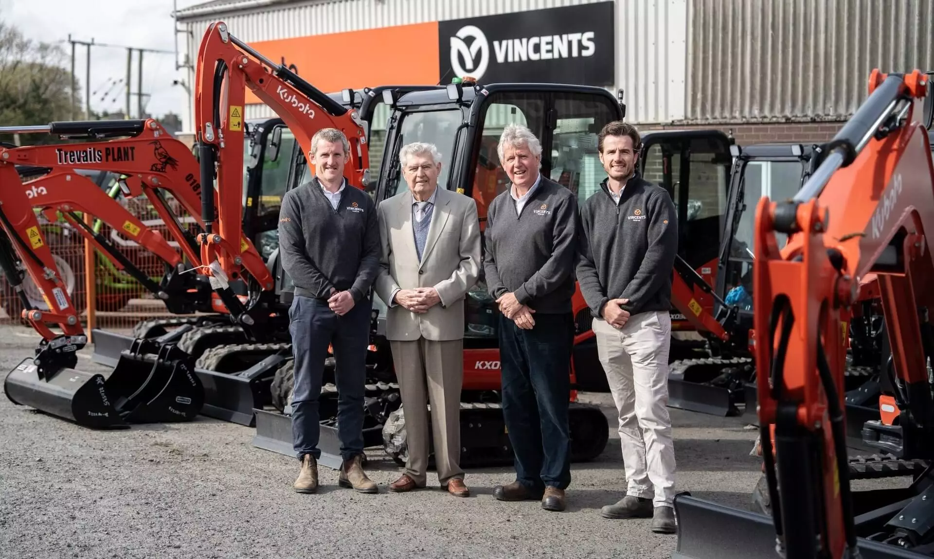 Vincent family members with Kubota mini diggers outside the Vincents depot