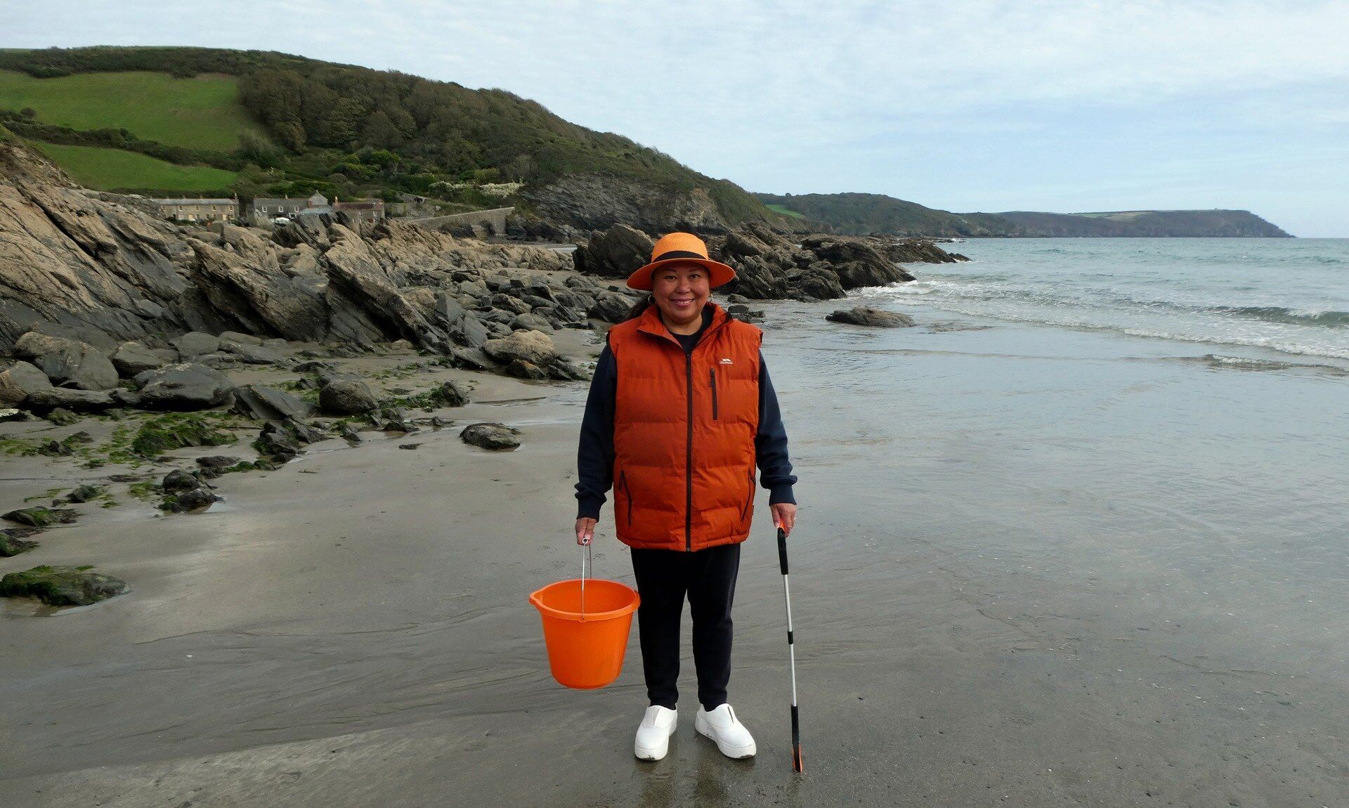 Rowena Castillo-Nicholls with a bucket and litter picker on West Portholland Beach