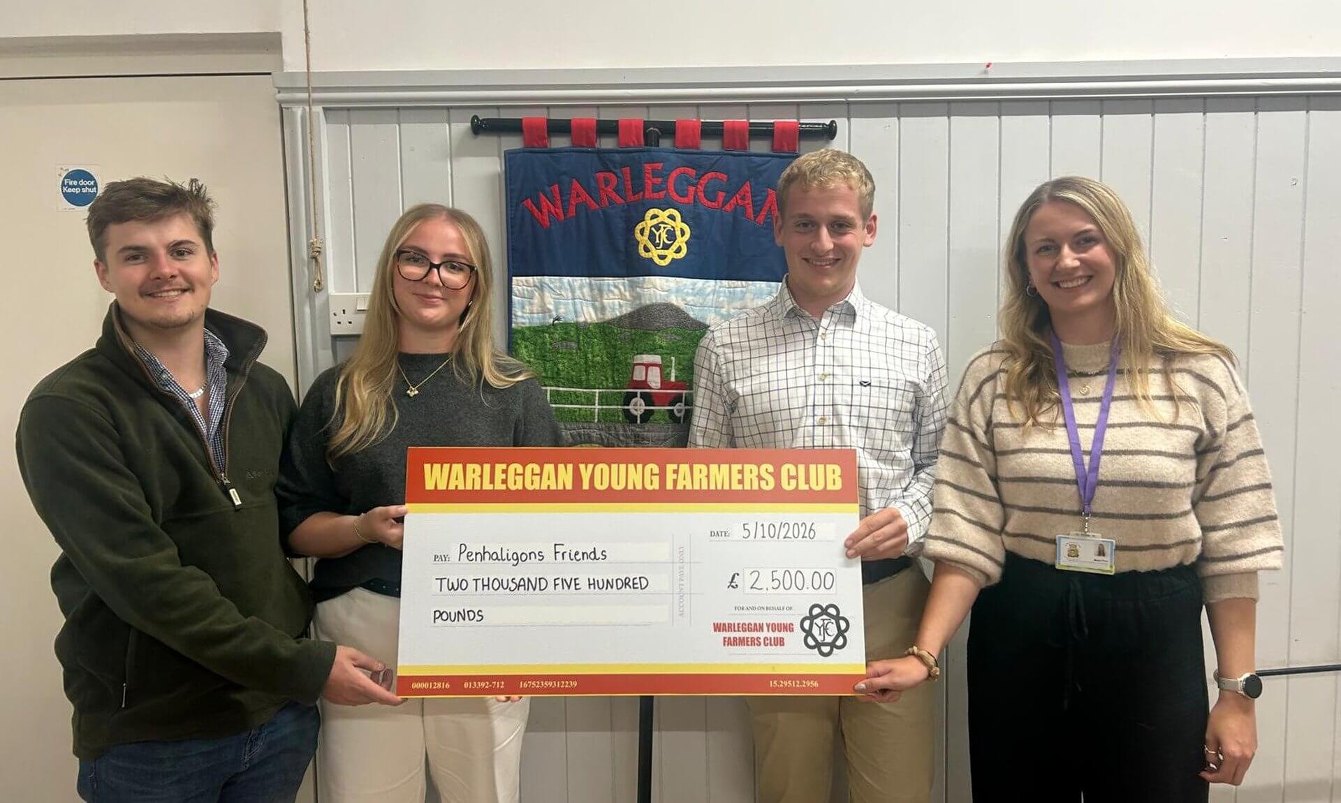 Warleggan Young Farmers Club members holding a £2,500 cheque for Penhaligon's Friends